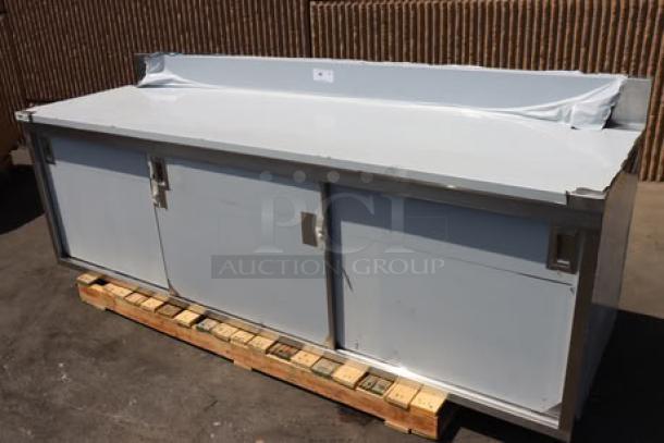 Regency stainless steel table, model 600EBTB3096D, 30"x96", with enclosed base, sliding doors, adjustable midshelf, and 6" backsplash.