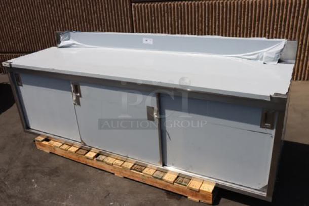 Regency 600EBTB3096D stainless steel table, 30" x 96", enclosed base, sliding doors, 16 gauge Type 304, 6" backsplash.