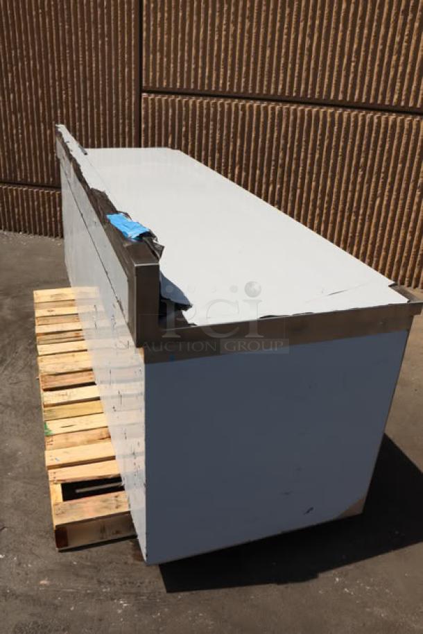 BRAND NEW Regency 600EBTB3096D stainless steel table with sliding doors, adjustable midshelf, and 6" backsplash on pallet.