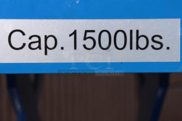 "Cap. 1500lbs." label on blue Vestil CART-PN-1500 hydraulic elevating cart.