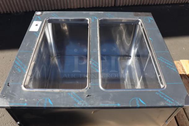 Brand new Delfield N227P 12-gallon drop-in freezer, stainless steel lids, minor dent on right side panel, S/N: 2504820100130.