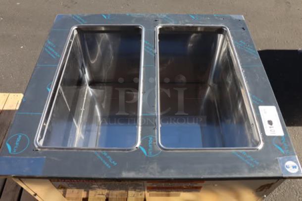 Brand new Delfield N227P 12-gallon drop-in freezer with stainless steel lids. Minor dent on right side panel. Model: N227P.