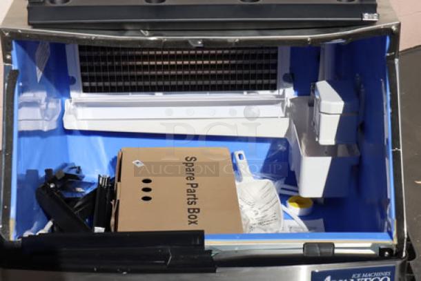 Hoshizaki AM-50BAJ ice machine, air cooled, 51 lb capacity, visible dent on top, potential door frame damage, spare parts included.