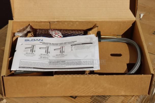 Brand new Sloan 3335016 Optima polished chrome solar-powered sensor faucet in box, includes installation guide.