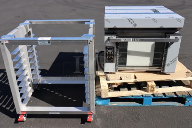 Cadco XAF-193 convection oven with broken outer glass next to aluminum oven stand on pallets. New, scratch-n-dent.