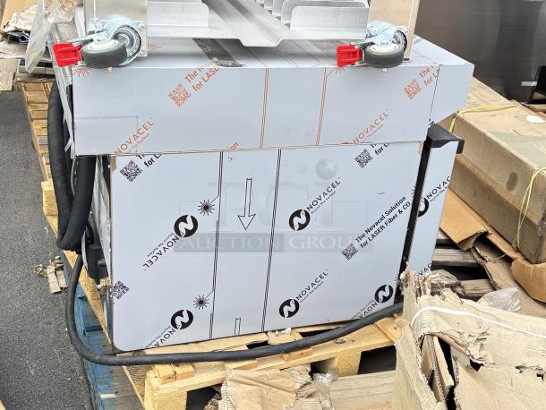 Cadco Rossella XAF-193 countertop convection oven, Novacel packaging. Outer glass pane broken, on aluminum stand with casters. Model visible.