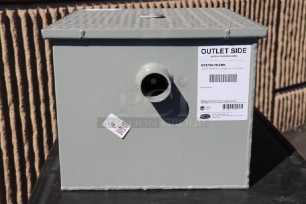 Brand new Zurn Elkay GT2700-15-2NH 30 lb. grease trap, 15 GPM, 2" no-hub connections, outlet side label visible.