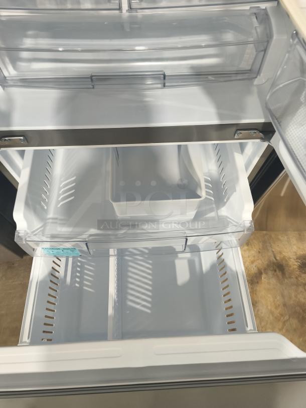 Brand new LG 22 cu ft French Door Refrigerator, model LFDS22520S, scratch and dent, interior view with shelves and drawers.