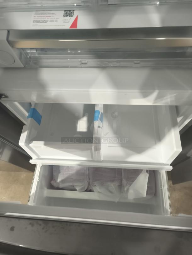 Frigidaire Gallery 20 cu ft French Door Refrigerator, model GRFN2023AF00, new condition, interior view of freezer drawers.