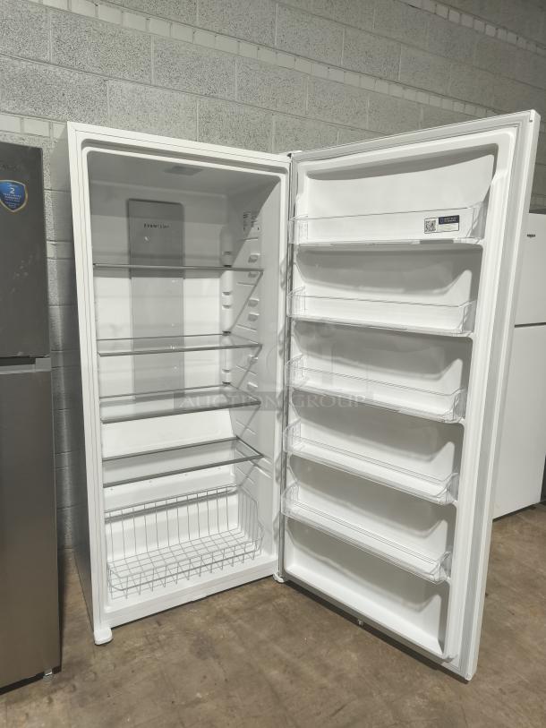 Frigidaire 20 cu ft upright freezer, model FFUE2024AW, garage-ready, new condition, spacious shelves, white interior.