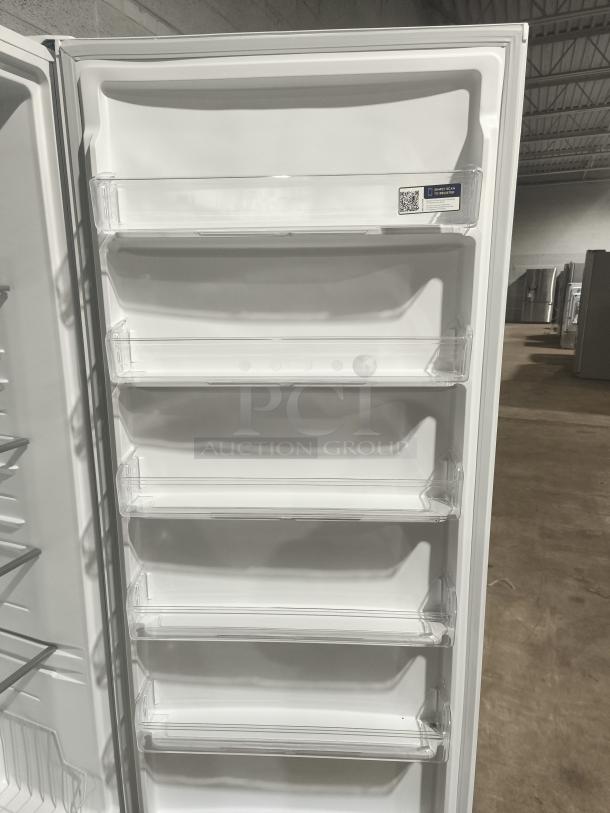 Frigidaire 20 cu ft garage-ready upright freezer, model FFUE2024AW, new, with adjustable shelves and door storage.