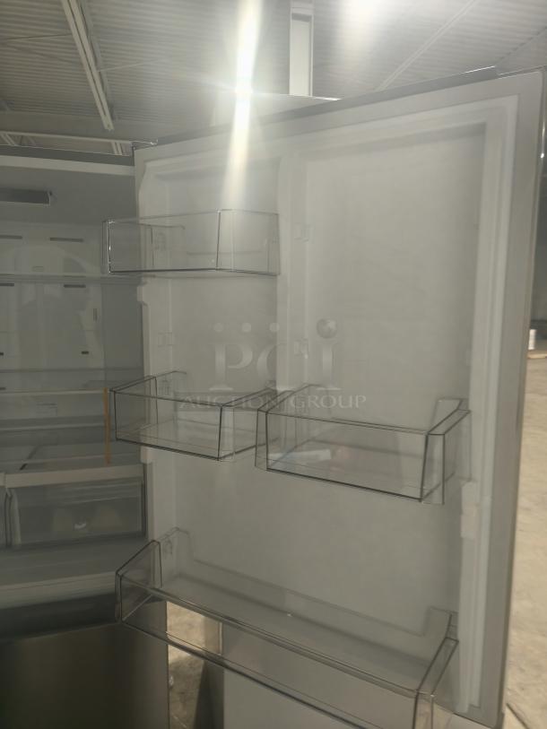 Midea 18.7 cu. ft. bottom-mount freezer refrigerator, model MRB19B7AST, new condition, interior shelves visible.