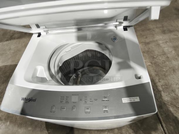 Whirlpool 1.6 cu. ft. Electric Stacked Laundry Center, Model WET4024HW, brand new with control panel and open lid.
