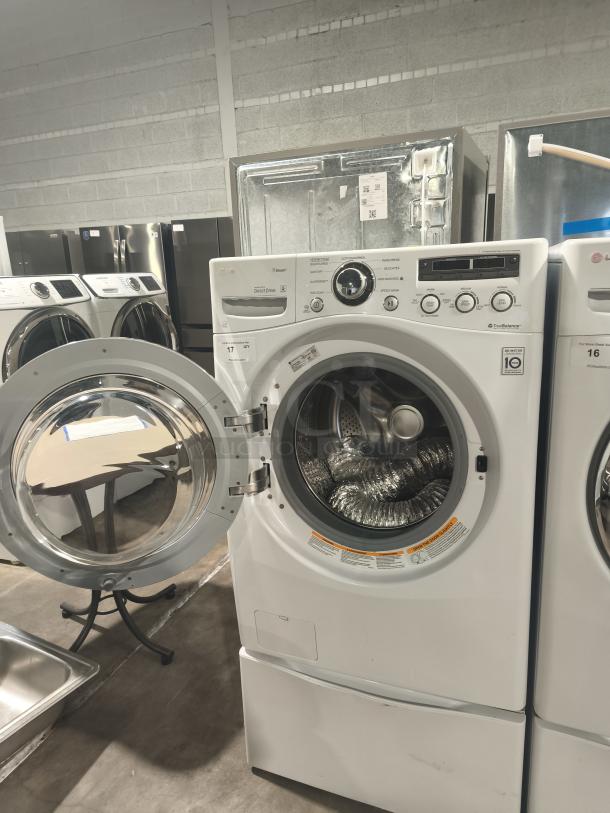 LG WM2650HWA SteamWasher™ front-load washer, tested and working, clean condition, open door showing stainless drum.