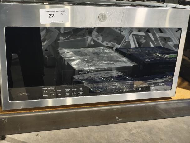 BRAND NEW GE Profile 2.1 cu ft Over-the-Range Sensor Microwave Oven, model PVM9005SJ8SS, with minor scratches.