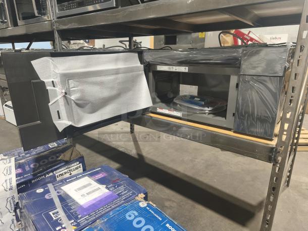 BRAND NEW GE Profile 2.1 cu ft Over-the-Range Sensor Microwave Oven, model PVM9005SJ8SS, minor scratches, protective wrapping intact.