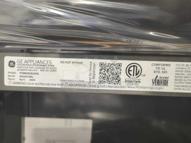 GE Profile microwave, model PVM9005SJ8SS, new scratch and dent condition. Visible label with manufacturing details.