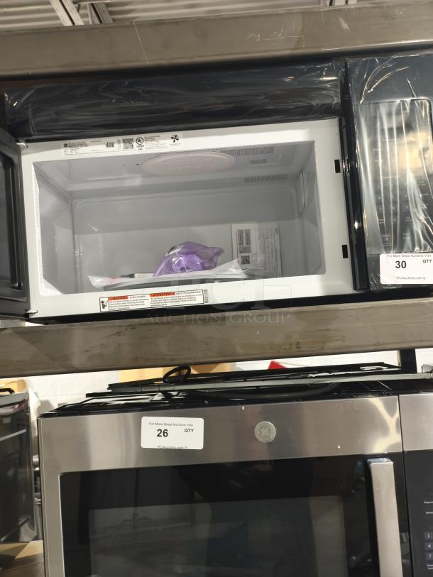 BRAND NEW SCRATCH AND DENT GE 1.6 cu ft Over-the-Range Microwave Oven, model JVM3160DFBB, black, tags visible.