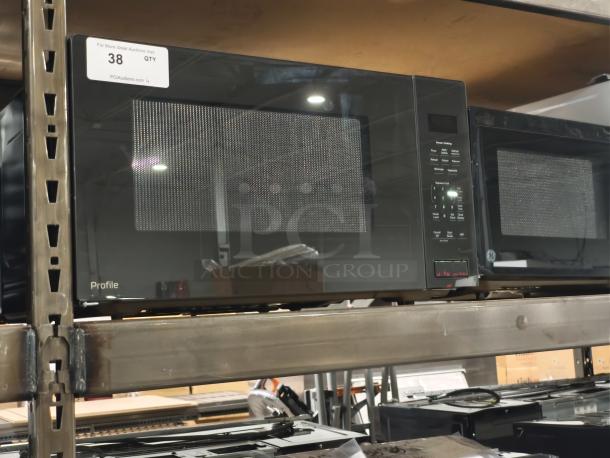 BRAND NEW GE Profile 2.2 cu ft Built-In Sensor Microwave Oven, Model PCWK22U1WDD, scratch and dent condition, label visible.