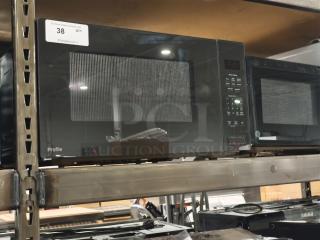 BRAND NEW GE Profile 2.2 cu ft Built-In Sensor Microwave Oven, Model PCWK22U1WDD, scratch and dent condition, label visible.
