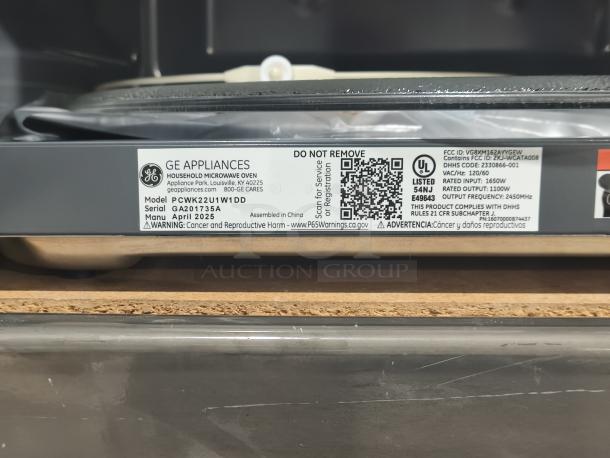 GE Profile 2.2 cu ft Built-In Sensor Microwave, Model PCWK22U1WDD, brand new with minor scratches, label details visible.