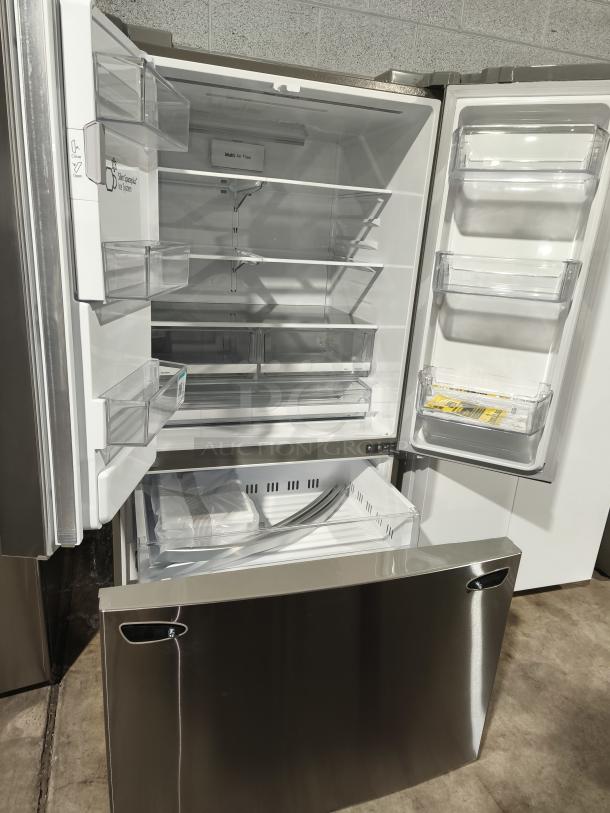 NEW LG 28 cu ft 3-Door Smart French Door Refrigerator, model LRFS28XBS/05, with ice and water dispenser, open showing shelves and compartments.