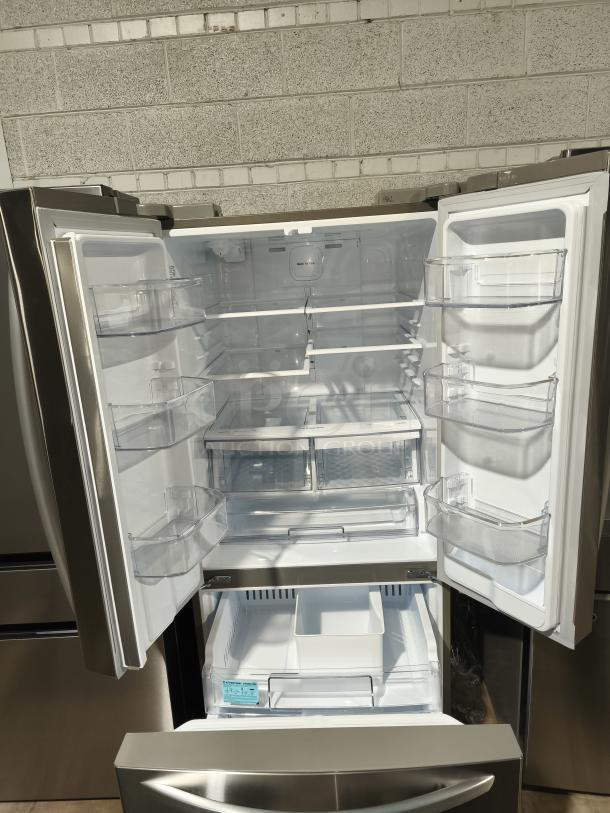 LG 21.8 cu ft 3-Door French Door Refrigerator, model LFDS22520S/06, new condition, open doors showing shelves and bins.