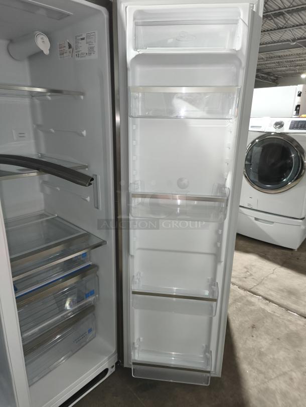 NEW Frigidaire Gallery side-by-side refrigerator, model GRSS2652AFA, 25.6 cu ft, metal shelves, open door view, tags visible.