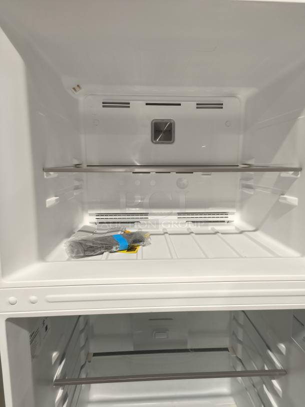 NEW Midea MRT18D3BST 18.1 cu ft top-freezer refrigerator, pristine interior, garage-ready, includes manuals and accessories.