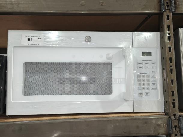 New GE 1.6 cu ft over-the-range microwave oven, model JVM3160DF9WW, pristine condition, white finish, features digital display and control panel.