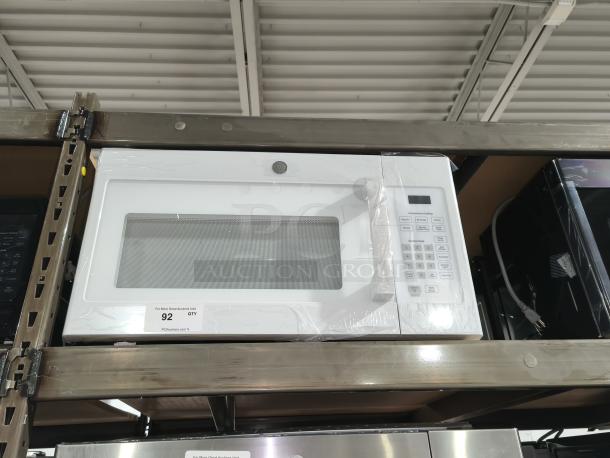 NEW GE 1.6 cu ft Over-the-Range Microwave Oven, Model JVM3160DF9WW, white finish, keypad controls, in original packaging.
