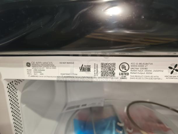 Brand new GE 1.6 cu ft over-the-range microwave, model JVM3162RJSS. Scratch and dent. Tags show model, serial, and compliance info.