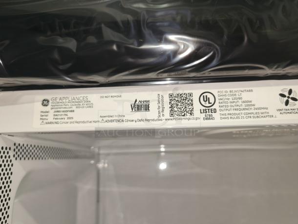 Brand new GE 1.6 cu ft Over-the-Range Microwave, model JVM3160DFBB. Scratch and dent item with labels showing specs and warnings.
