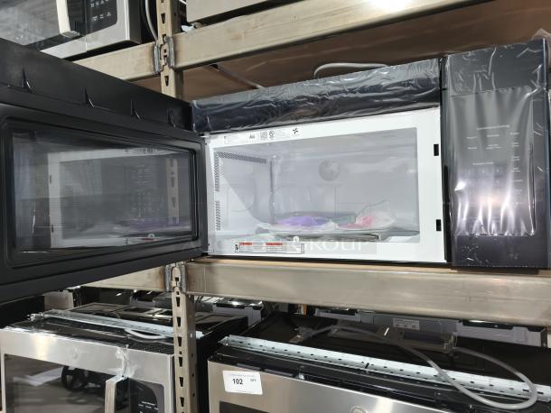 BRAND NEW GE JVM3160DFBB 1.6 cu ft over-the-range microwave oven with scratch and dent. Keypad and interior visible.