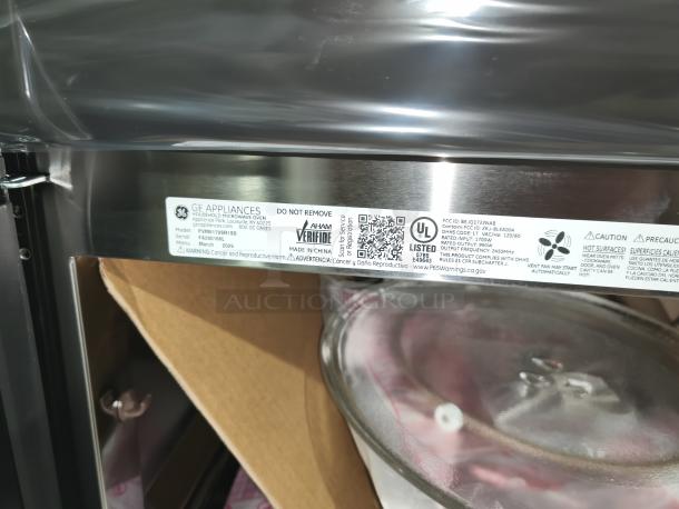 BRAND NEW GE Profile PVM9179SRSS 1.7 cu ft convection microwave oven with visible tag showing model and safety warnings.
