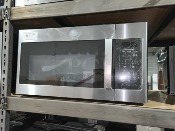 BRAND NEW GE Over-the-Range Sensor Microwave Oven, Model JVM617YK6FS. Minor dents, tags indicate model and quantity.