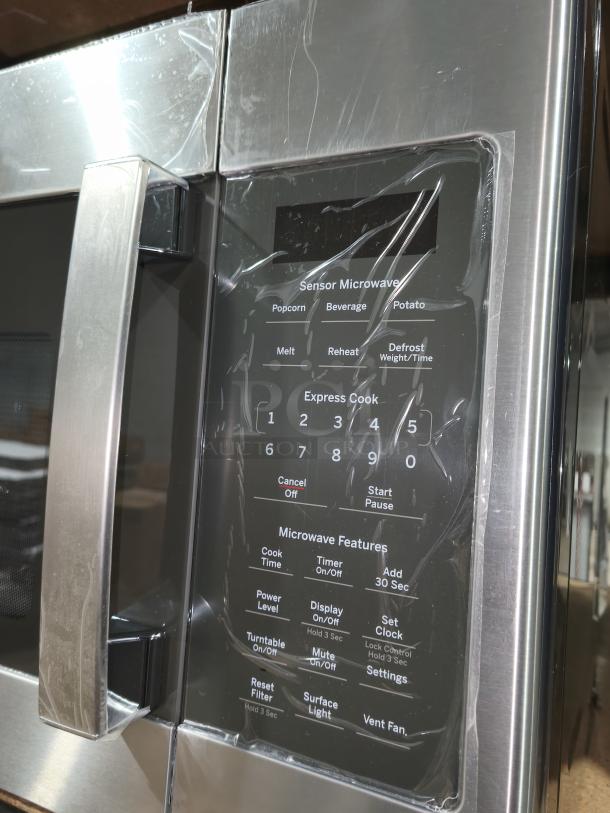 Brand new GE over-the-range microwave model JVM617YK6FS, features sensor cooking, visible control panel, minor dents.