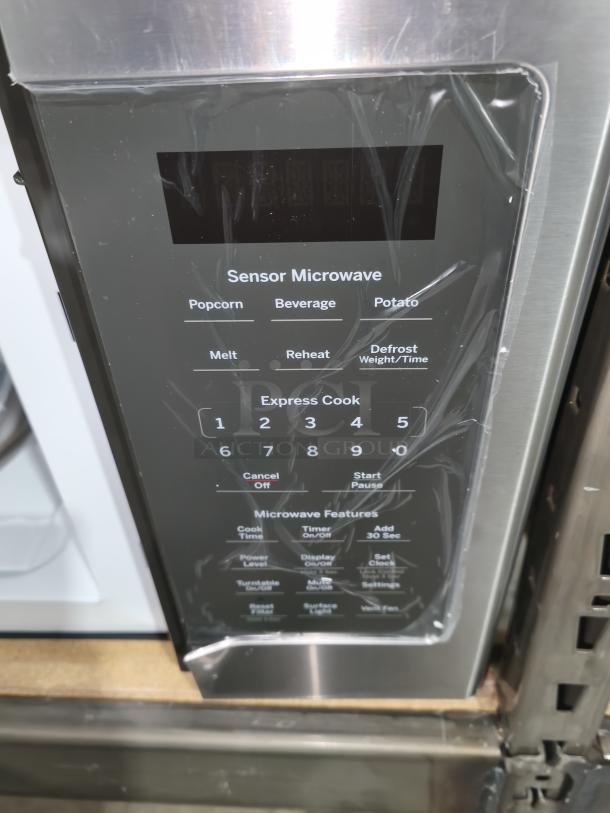 BRAND NEW GE 1.7 cu ft Over-the-Range Microwave, Model JVM6175SK6SS, control panel view with sensor buttons.