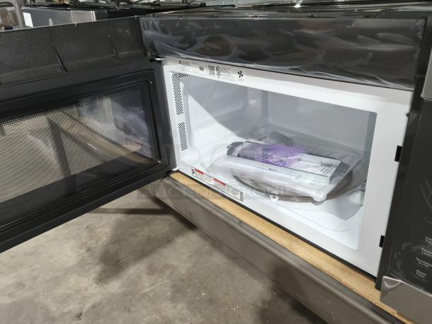 BRAND NEW GE over-the-range microwave, model JVM6175SK6SS, 1.7 cu ft, sensor features, open door, interior view, manuals inside.