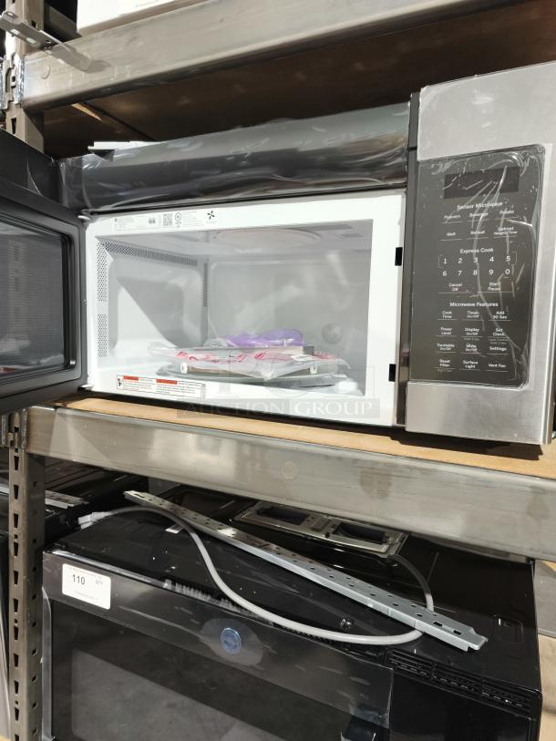 Brand new GE 1.7 cu ft over-the-range microwave, model JVM6175YK6FS, with minor scratches. Visible control panel and interior.