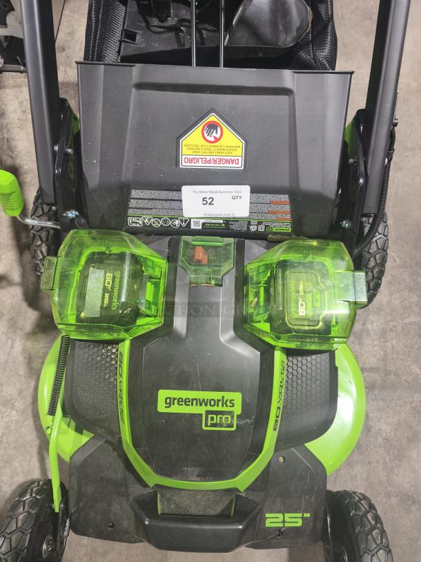 Greenworks 80V 25" self-propelled cordless mower, model LMB405, tested and working, visible safety warnings and auction label.