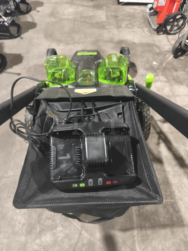 Greenworks 80V 25" self-propelled cordless mower, model LMB405, in tested and working condition, showing dual battery compartments.