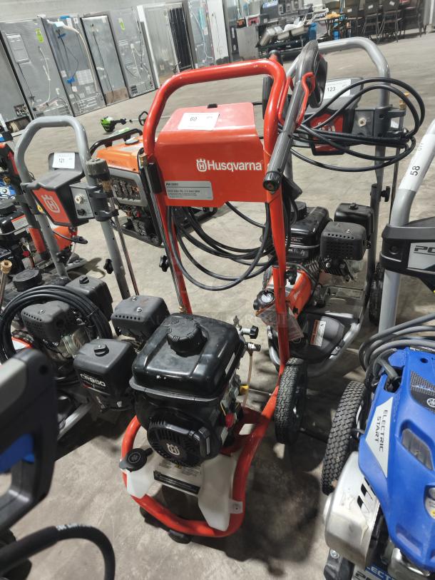 Husqvarna PW 3200 PSI pressure washer, tested and working, red frame, visible labels, clean and well-maintained.