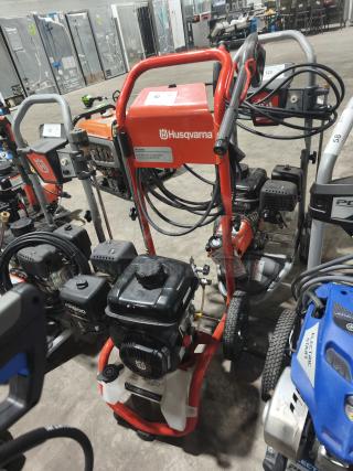 Husqvarna PW 3200 PSI pressure washer, tested and working, red frame, visible labels, clean and well-maintained.