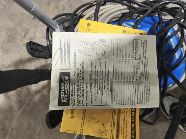 PowerStroke PS141913 pressure washer with manual and cords visible. Manual includes safety and operation instructions.