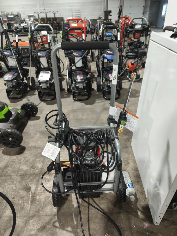 Husqvarna PW2300 electric pressure washer, model PW2300, in excellent condition, with visible hose and power cord.