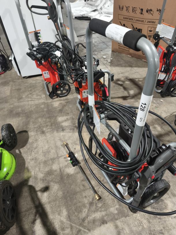 Husqvarna PW2300 electric pressure washer, coiled hose, and metal spray wand. Excellent condition; model labels visible.