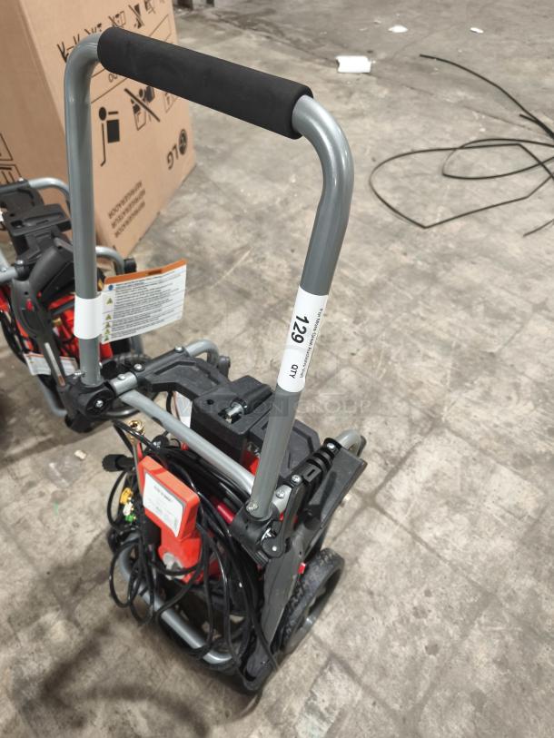 Husqvarna PW2300 electric pressure washer, tested and working, with durable handle and coiled hose, model label visible.