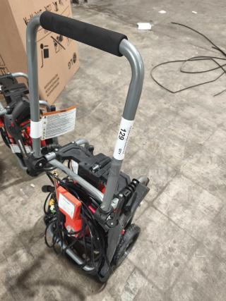 Husqvarna PW2300 electric pressure washer, tested and working, with durable handle and coiled hose, model label visible.