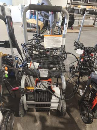 Husqvarna PW2300 Electric Pressure Washer, tested and working, features sturdy frame, hose storage, and user manual.